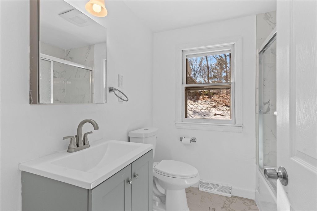 260 Great Road Stow, MA 01775 - Photo 20 of 32 a bathroom with a toilet sink and mirror