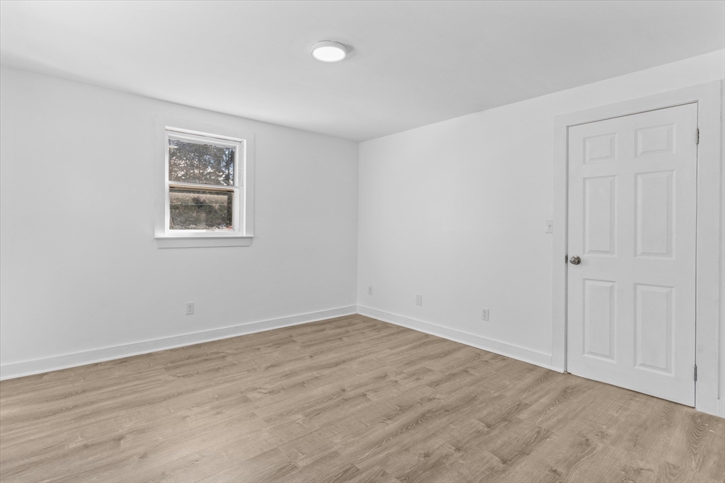 260 Great Road Stow, MA 01775 - Photo 23 of 32 a view of an empty room with wooden floor