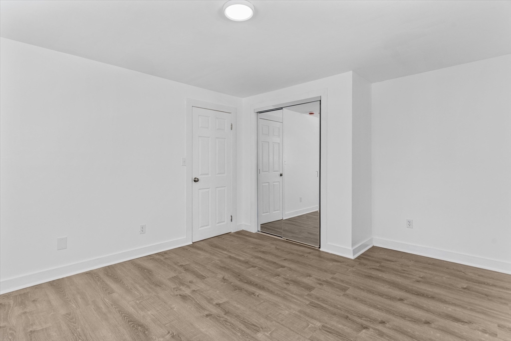 260 Great Road Stow, MA 01775 - Photo 24 of 32 a view of an empty room with wooden floor