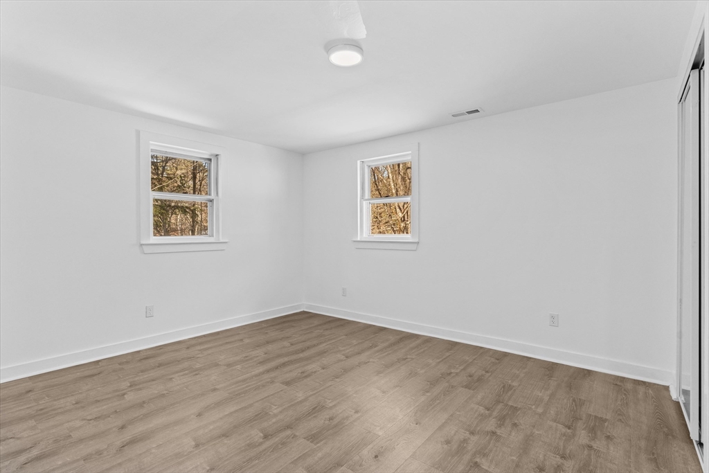 260 Great Road Stow, MA 01775 - Photo 26 of 32 an empty room with a painting and a window