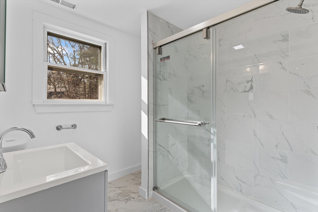 260 Great Road Stow, MA 01775 - Photo 28 of 32 a bathroom with a tub a sink and glass door