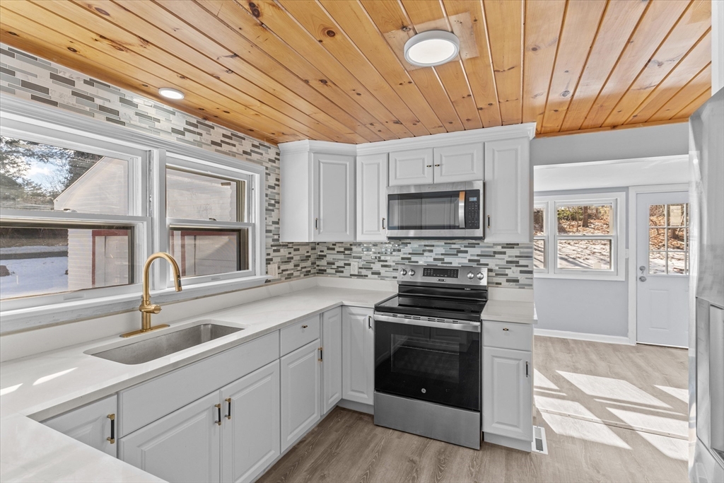 260 Great Road Stow, MA 01775 - Photo 4 of 32 a kitchen with granite countertop a sink stainless steel appliances and cabinets