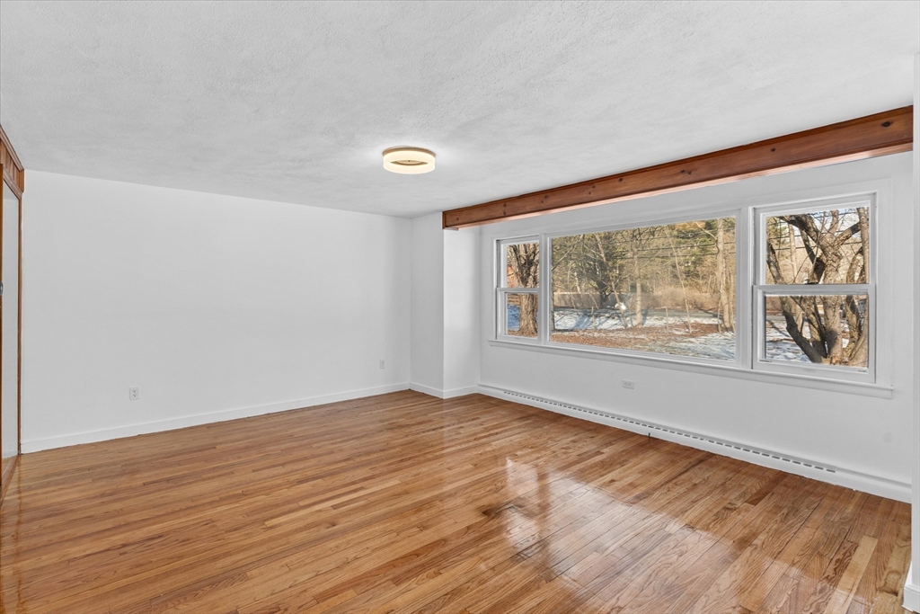 260 Great Road Stow, MA 01775 - Photo 7 of 32 wooden floor in an empty room with a window
