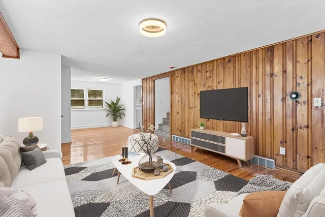 a living room with furniture and a flat screen tv