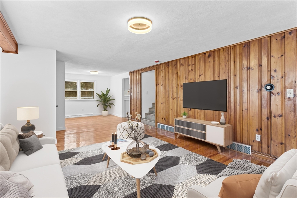 260 Great Road Stow, MA 01775 - Photo 8 of 32 a living room with furniture and a flat screen tv