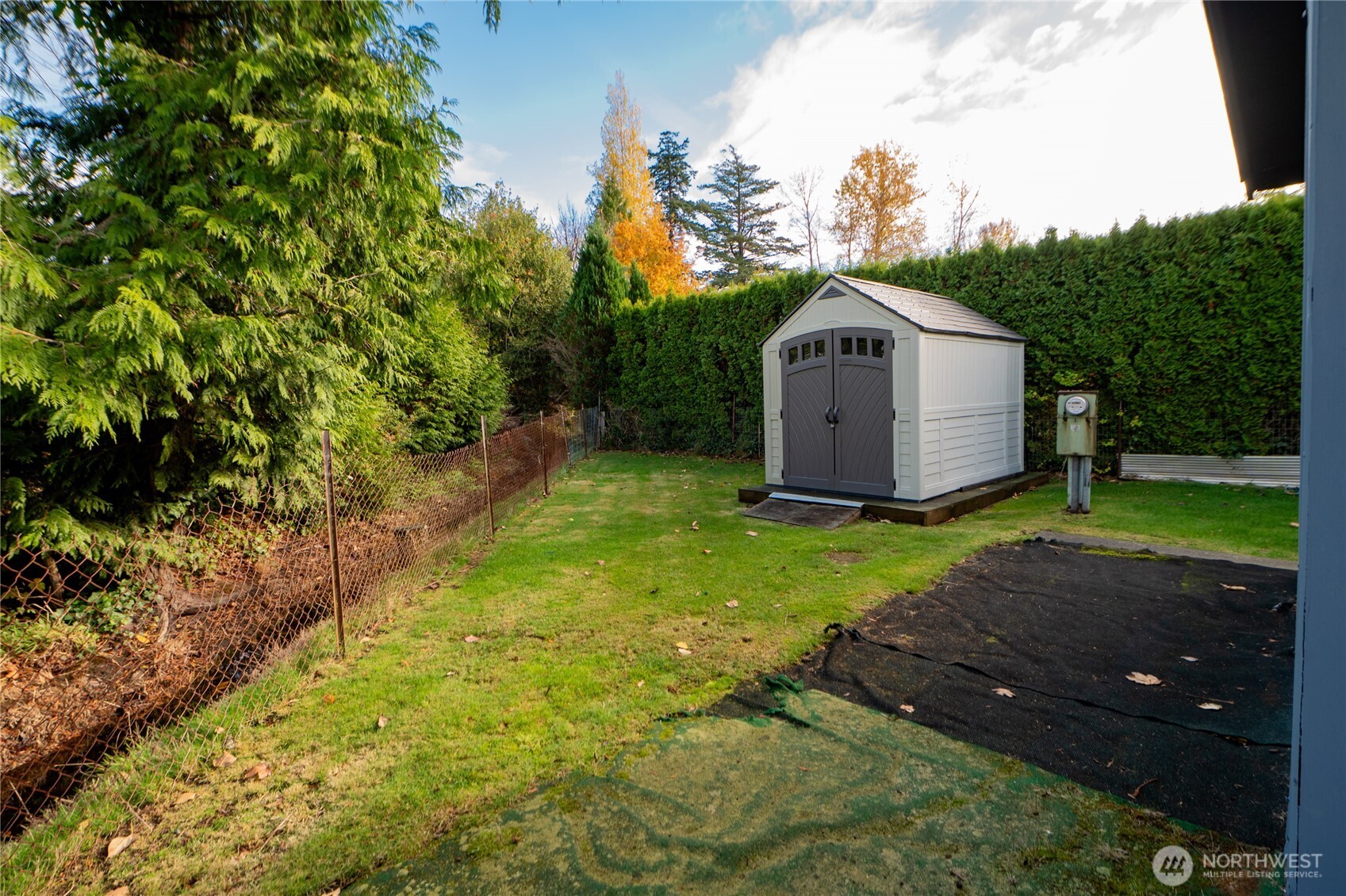 8370 Harborview Road, Unit 15 Blaine, WA 98230 - Photo 15 of 26 a view of a tiny house with a big yard and large trees