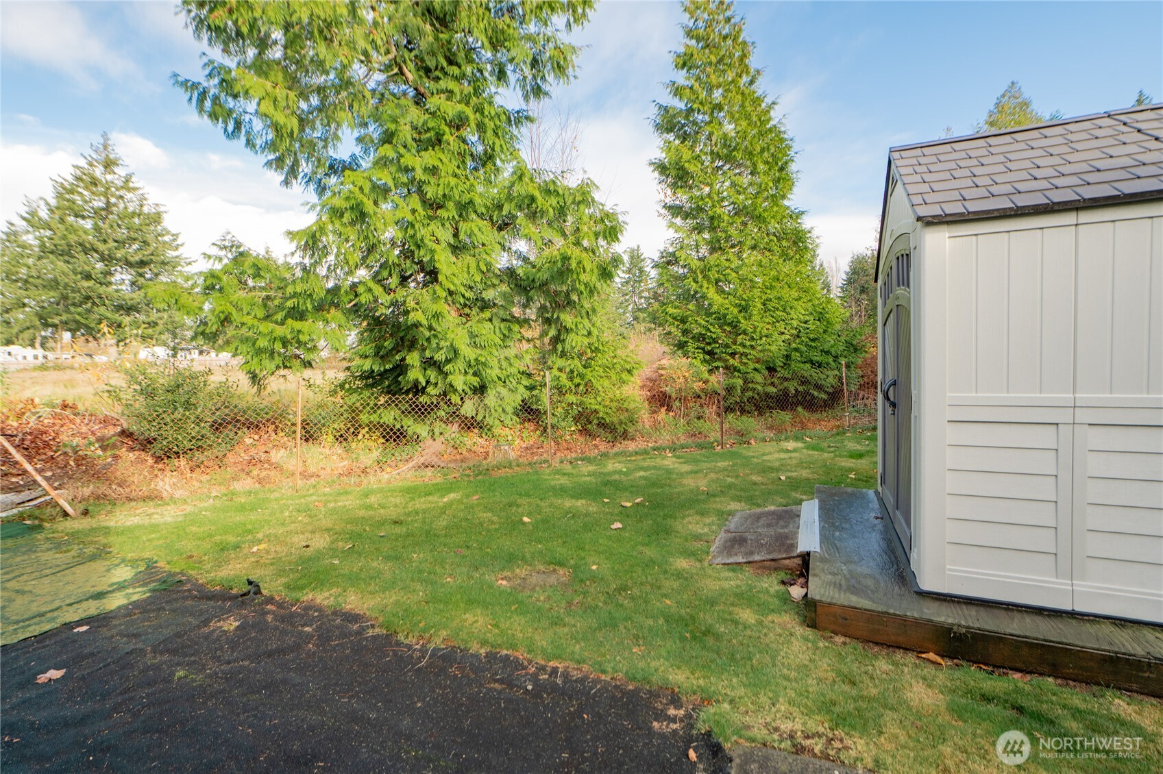 8370 Harborview Road, Unit 15 Blaine, WA 98230 - Photo 17 of 26 a backyard of a house with lots of green space