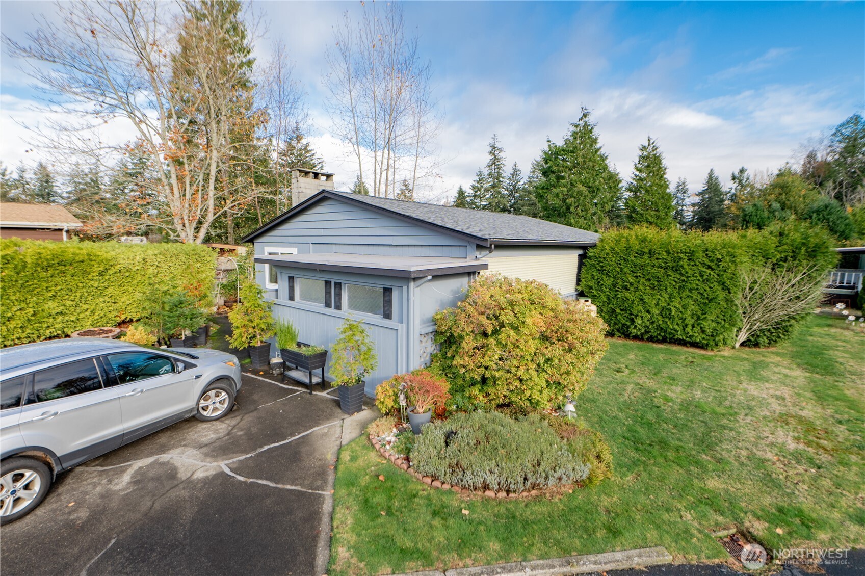 8370 Harborview Road, Unit 15 Blaine, WA 98230 - Photo 26 of 26 a front view of a house with garden