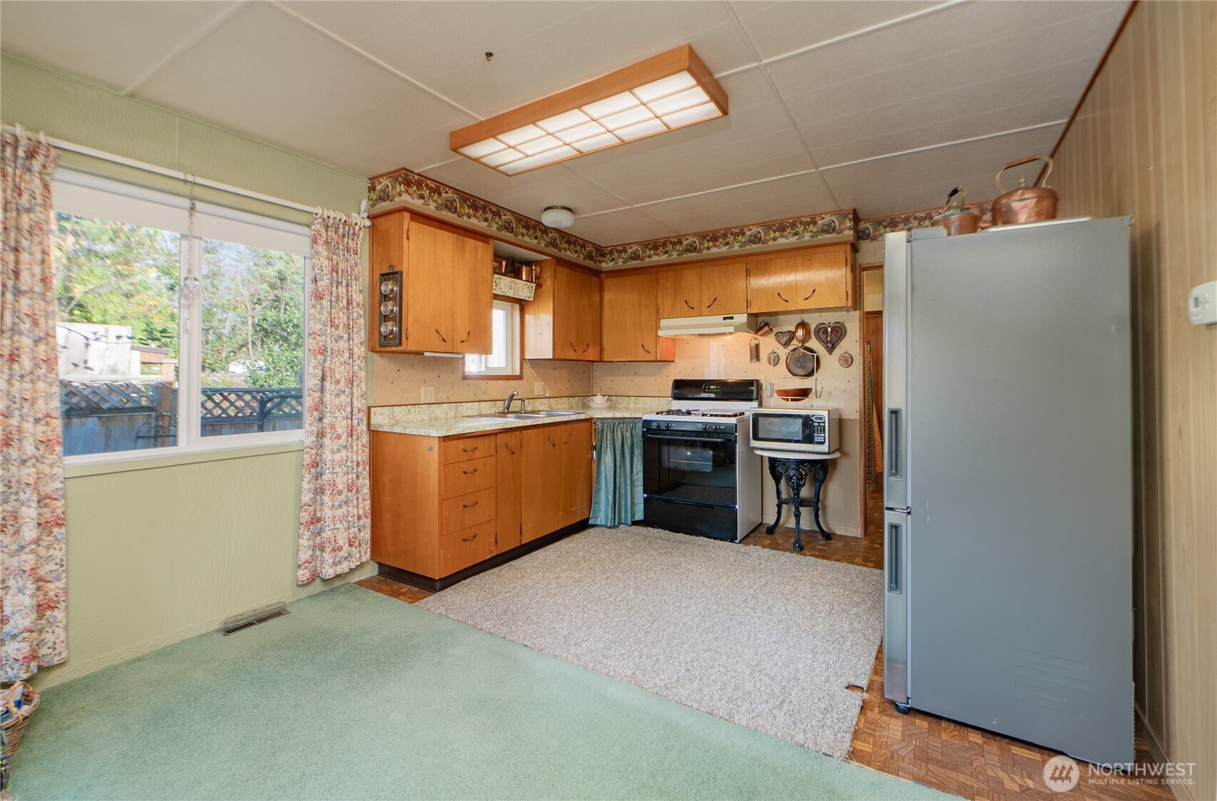 8370 Harborview Road, Unit 15 Blaine, WA 98230 - Photo 6 of 26 a kitchen with stainless steel appliances granite countertop a stove a refrigerator and a sink