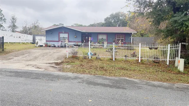 a view of a house with a yard and sitting area