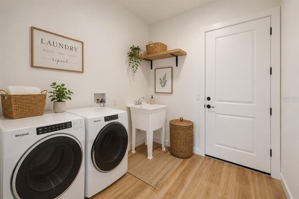 1215 Rio De Janeiro Avenue Punta Gorda, FL 33983 - Photo 57 of 65 a view of a hallway with washer and dryer