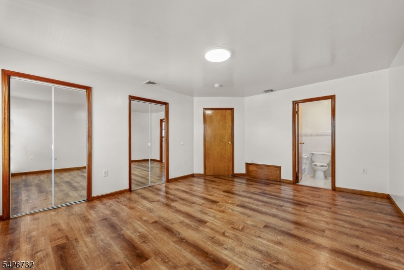 939 Grove Street Elizabeth, NJ 07202 - Photo 13 of 18 a view of an empty room with wooden floor and closet
