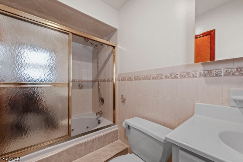 939 Grove Street Elizabeth, NJ 07202 - Photo 15 of 18 a bathroom with a shower and toilet
