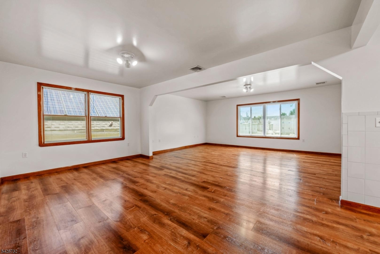 939 Grove Street Elizabeth, NJ 07202 - Photo 5 of 18 an empty room with wooden floor and windows