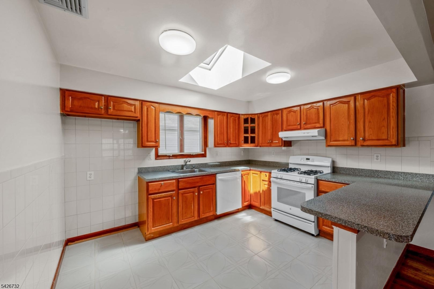 939 Grove Street Elizabeth, NJ 07202 - Photo 8 of 18 a kitchen with stainless steel appliances granite countertop a sink stove and refrigerator