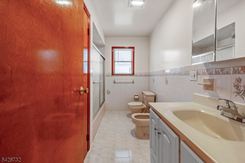 939 Grove Street Elizabeth, NJ 07202 - Photo 9 of 18 a bathroom with a sink and toilet
