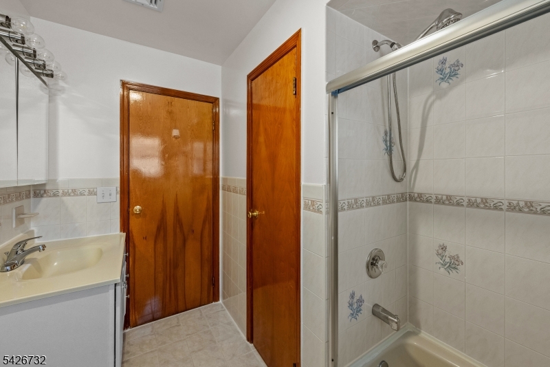 939 Grove Street Elizabeth, NJ 07202 - Photo 10 of 18 a bathroom with a shower and a sink