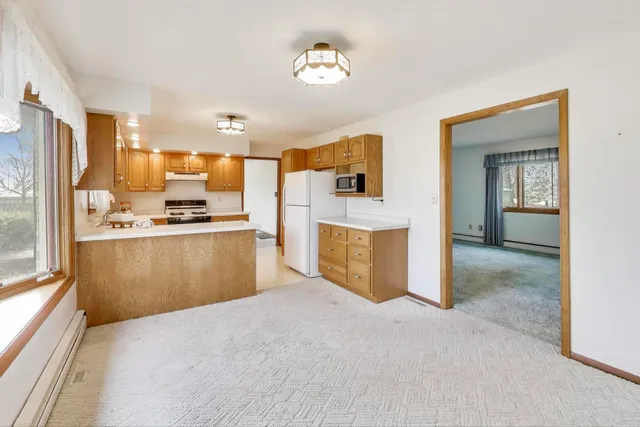 a view of kitchen with wooden floor