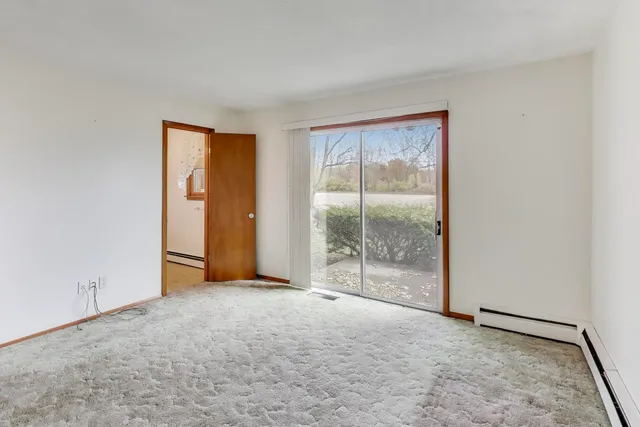 an empty room with sliding glass door