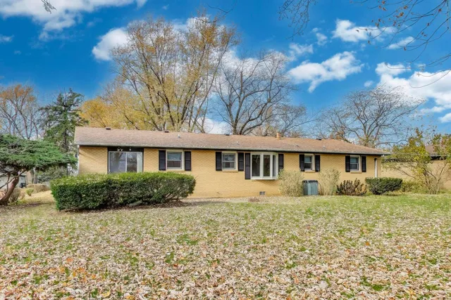 a view of a house with a yard covered with snow