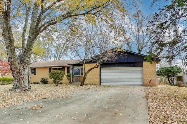 a house that has a tree in front of it