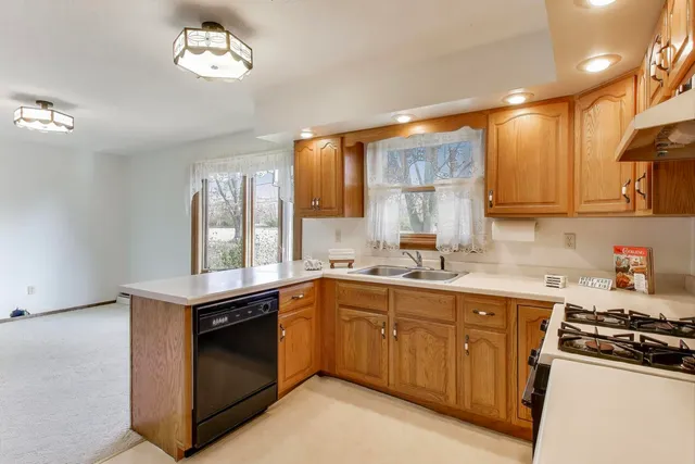 a kitchen with a sink stove and cabinets