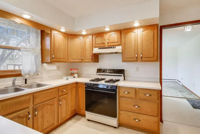 a kitchen with a stove top oven sink and cabinets