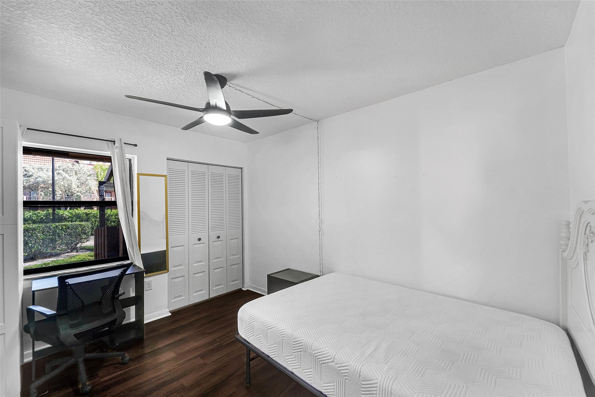 2698 North Nob Hill Road Sunrise, FL 33322 - Photo 11 of 27 wooden floor in an empty room with a window