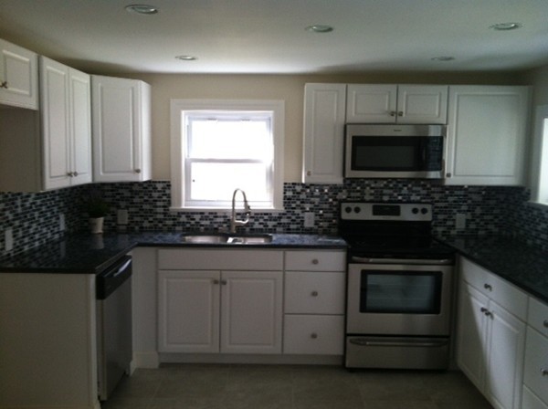 9 Johnson Road Sterling, MA 01564 - Photo 4 of 24 a kitchen with granite countertop a sink stove and microwave