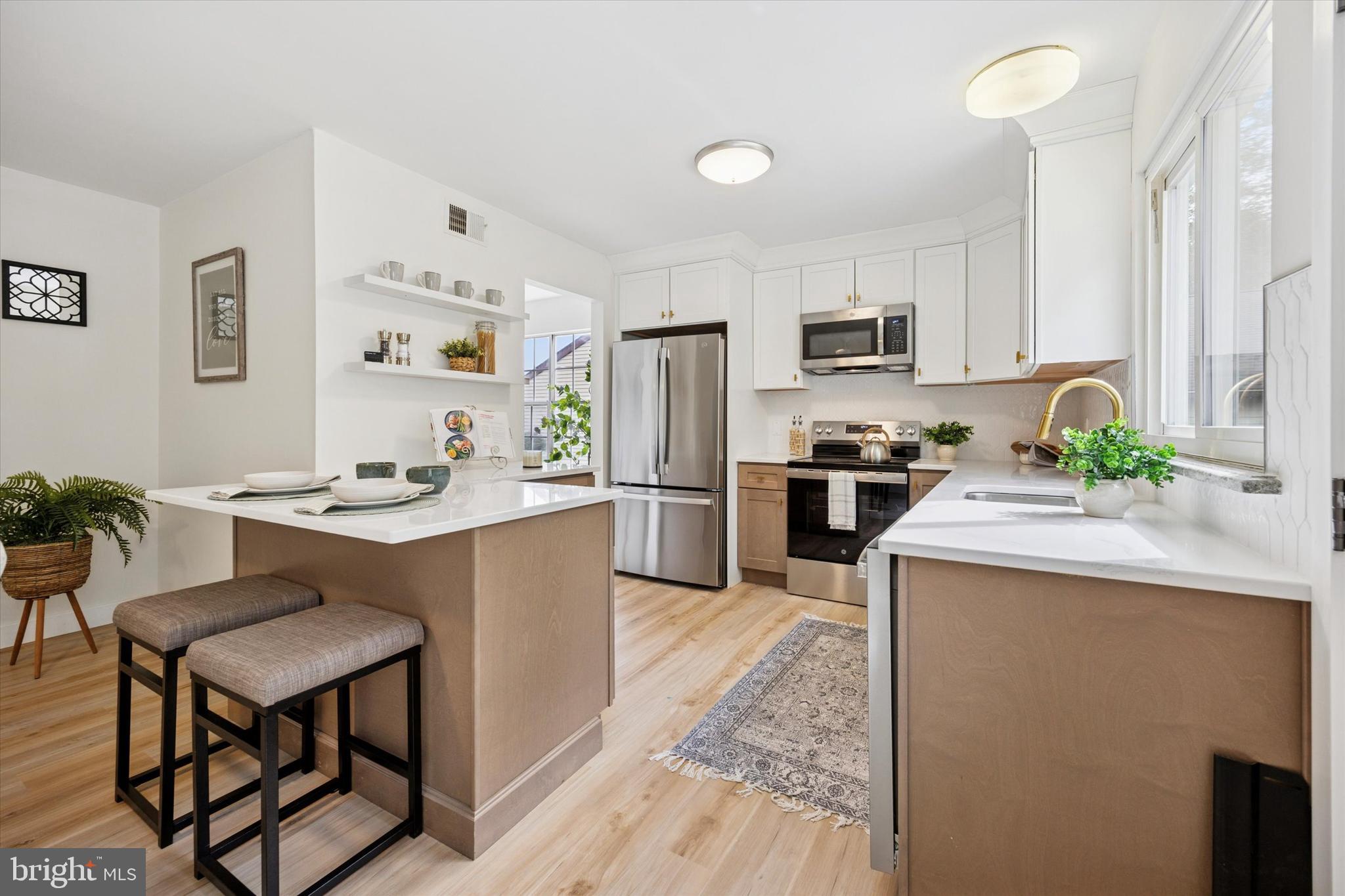114 Gramercy Place Southampton, NJ 08088 - Photo 11 of 23 a kitchen with kitchen island a stove a sink and a refrigerator