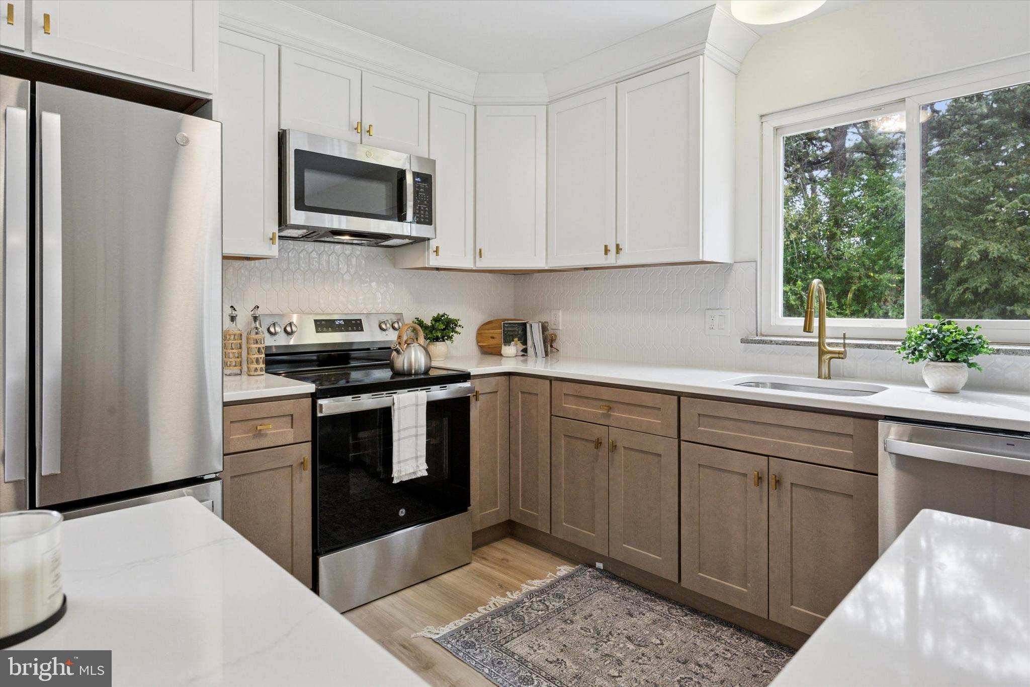114 Gramercy Place Southampton, NJ 08088 - Photo 13 of 23 a kitchen with a sink stove and microwave