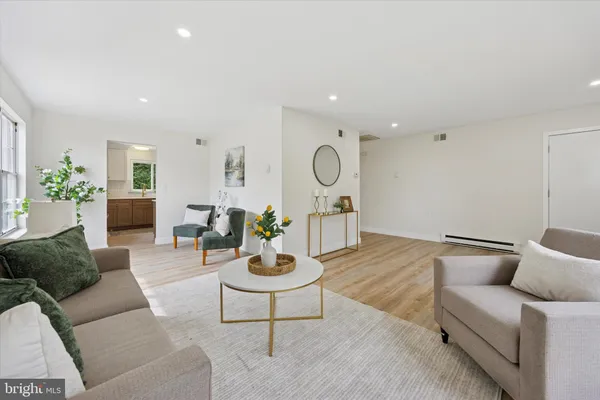 a living room with furniture and wooden floor