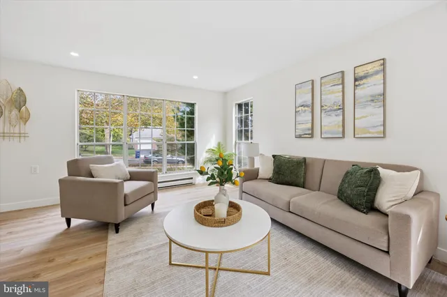 a living room with furniture and a large window