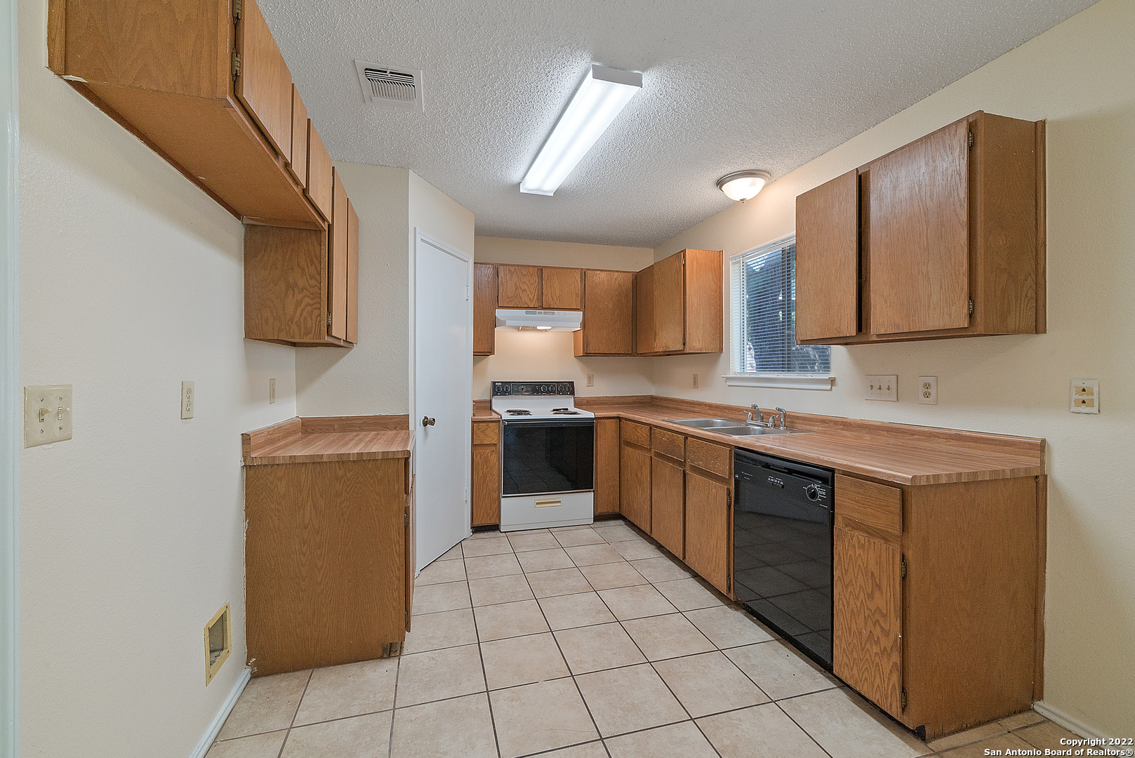 6122 Ridge Oak San Antonio, TX 78250 - Photo 11 of 31 a kitchen with stainless steel appliances granite countertop a sink counter space cabinets and a sink