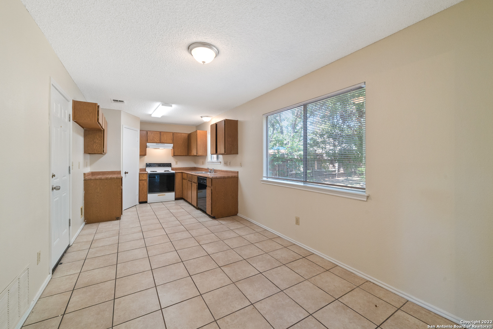 6122 Ridge Oak San Antonio, TX 78250 - Photo 16 of 31 a large white kitchen with a stove a sink dishwasher and a refrigerator