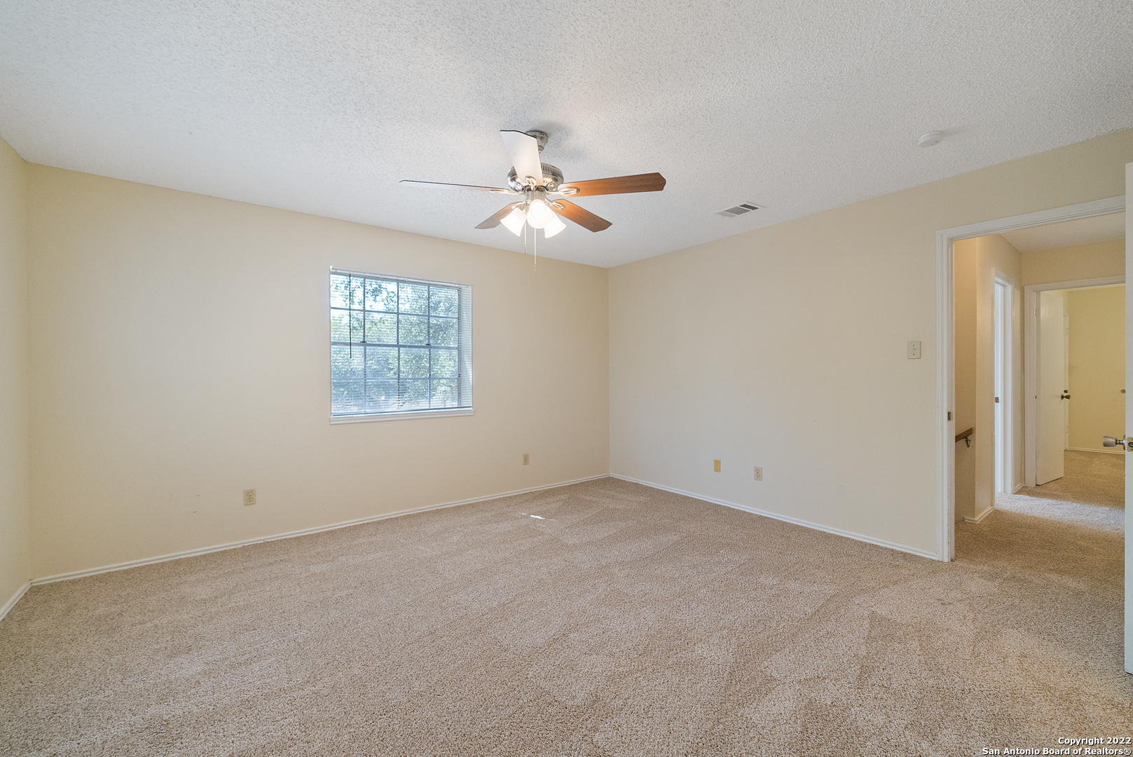 6122 Ridge Oak San Antonio, TX 78250 - Photo 19 of 31 an empty room with windows and fan
