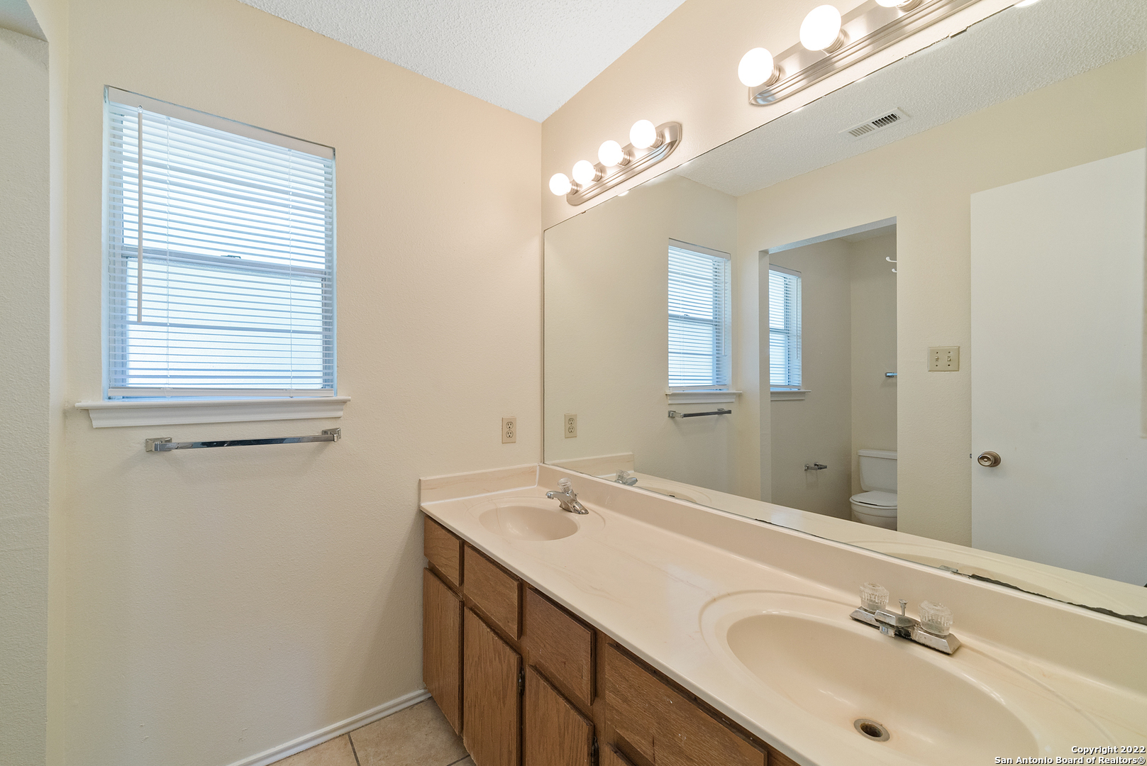 6122 Ridge Oak San Antonio, TX 78250 - Photo 21 of 31 a bathroom with a sink double vanity and a mirror