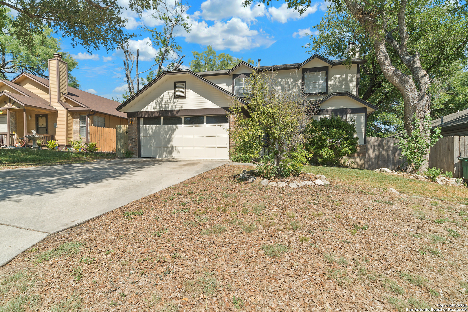 6122 Ridge Oak San Antonio, TX 78250 - Photo 3 of 31 a front view of a house with a yard and garage