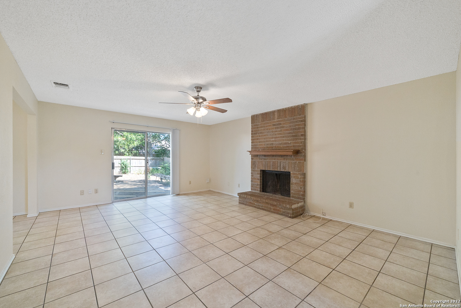 6122 Ridge Oak San Antonio, TX 78250 - Photo 7 of 31 a view of an empty room with a fireplace and a window