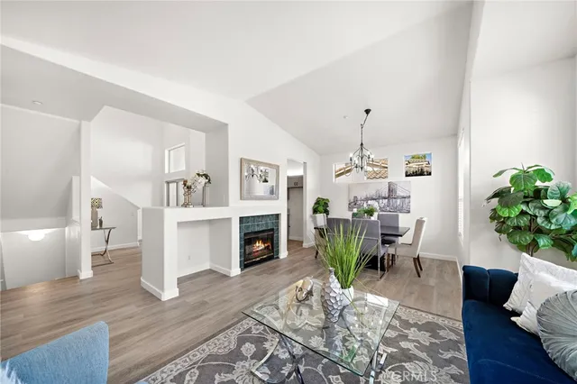 a living room with furniture fireplace and dining table