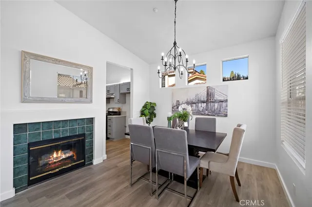 a view of a dining room with furniture wooden floor and a chandelier