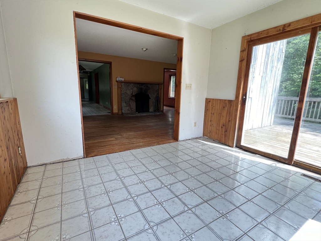 380 Lower Hampden Road Monson, MA 01057 - Photo 14 of 42 a view of empty room with wooden floor and large window