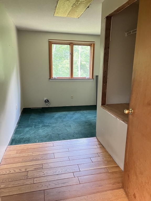 380 Lower Hampden Road Monson, MA 01057 - Photo 19 of 42 an empty room with wooden floor and windows