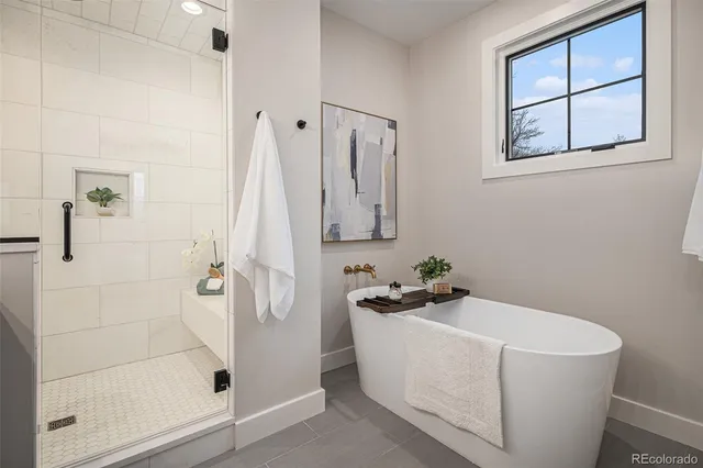 a white bath tub sitting next to a shower