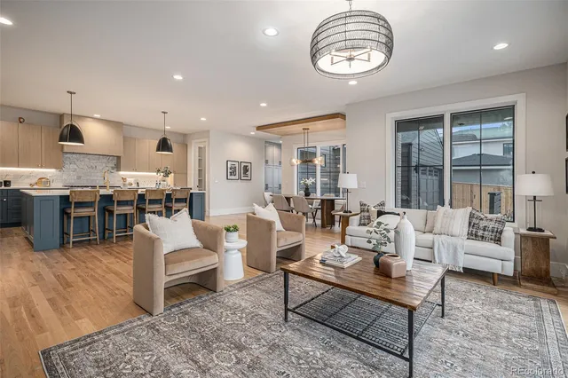 a living room with lots of furniture and kitchen view