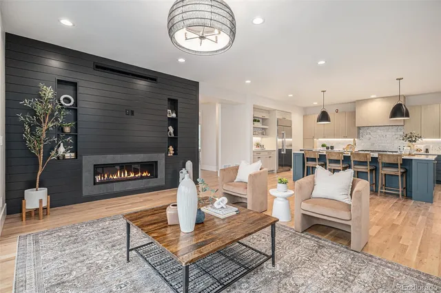 a living room with fireplace furniture and a wooden floor