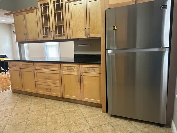 a kitchen with stainless steel appliances granite countertop a refrigerator and a sink
