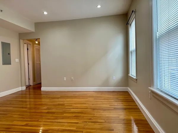 a view of room with window and wooden floor