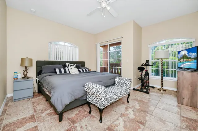 a bedroom with a bed chair and a window