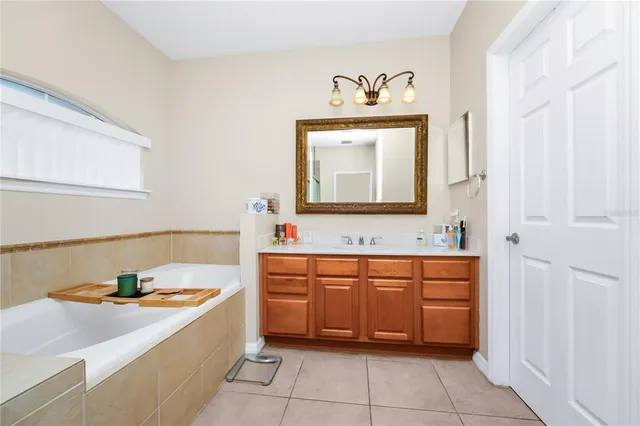 a bathroom with a sink vanity and mirror